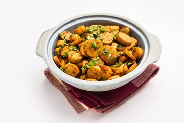 Stir fried taro roots. Arbi ki sabji, ghuiya masala curry Sabzi or arvi dum Masala. Garnished with coriander