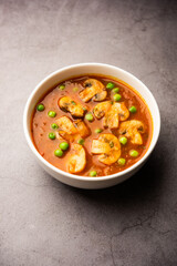 Mushroom and Pea Curry with Roasted Garlic, Indian food served in a bowl