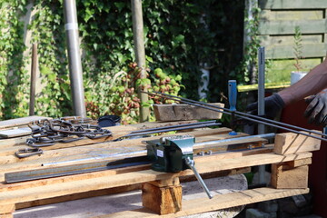 Construction worker equipment close up photo. Steel wire, pliers, steel bars top view. 