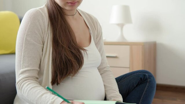 Cute Pregnant Woman Make Video Call Smartphone Online Consultation With Doctor By Mobile Phone. Young Ledy In Pregnancy Have Fun Spend Time On Floor At Home. Motherhood, Medicine Health Care Concept