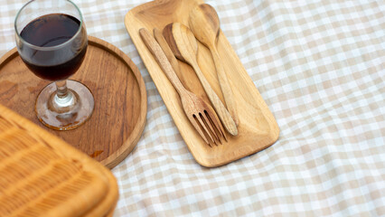 utensils on a plaid picnic mat