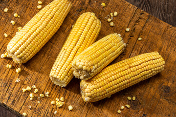 Corn on the cob on rustic wooden background.
