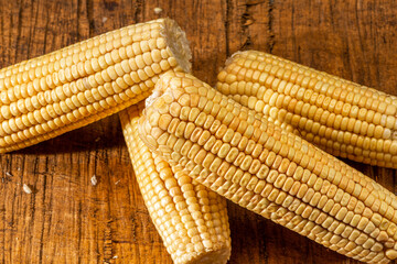 Corn on the cob on rustic wooden background.
