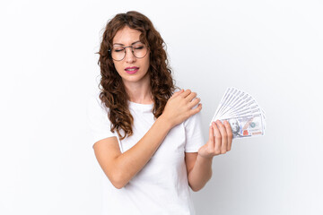Young woman with curly hair taking a lot of money isolated background on white background suffering from pain in shoulder for having made an effort