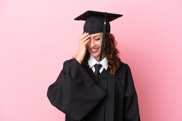 Young university graduate woman isolated on pink background laughing