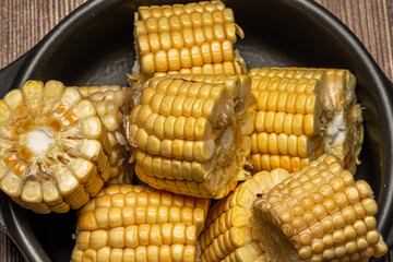 Corn on the cob on rustic wooden background.