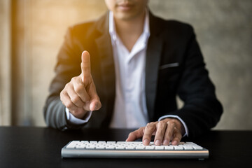 Close up of hands and fingers push the invisible button on screen and typing the keyboard.