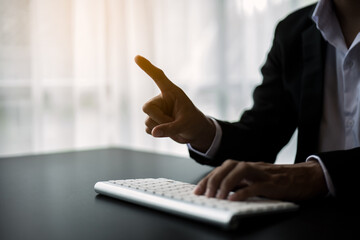 Close up of hands and fingers push the invisible button on screen.