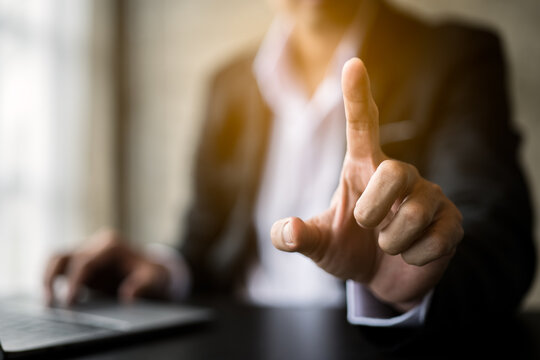 Close up of hands and fingers push the invisible button on screen.