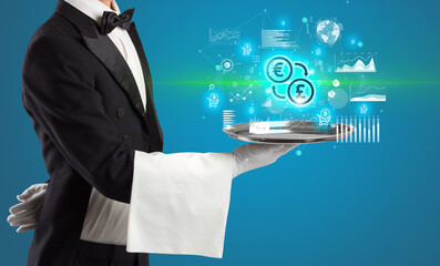 Handsome young waiter in tuxedo holding currency icons on tray