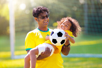 Brazilian father and son play football. Go Brazil.