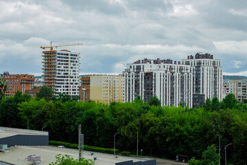 Residential complex under construction with big crane on site. New aparments buildings under construction.