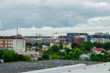 Residential complex under construction with big crane on site. New aparments buildings under construction.