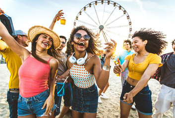 Multiracial group of friends having fun dancing on the beach - Happy people enjoying music festival...