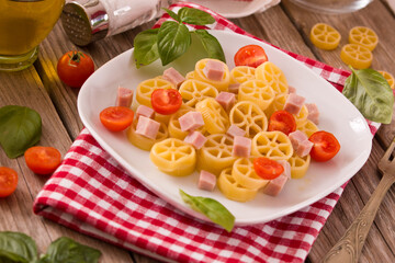 Ruote pasta with tomato and ham.