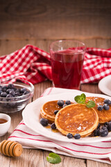 Pancakes with blueberries and chocolate cream.