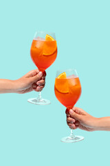 Two cocktails in hands on blue background