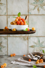 Ripe juicy raspberries in a small bowl. Summer harvest of delicious berries.