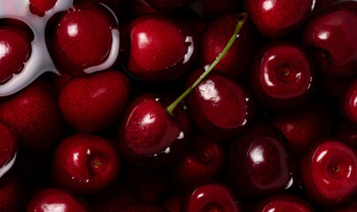 Red juicy sweet cherries. Juicy maroon fruit close-up. Cherries in magnification with light reflections. Sweet fruit.