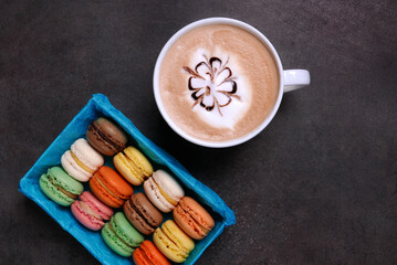 White coffee and colorful cookies ...