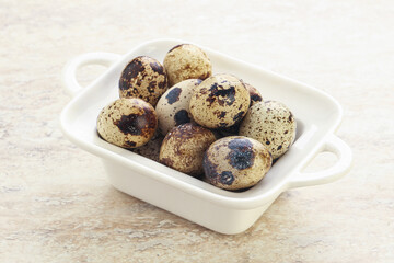 Raw quail eggs heap in the bowl