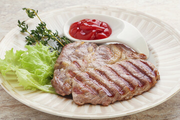 Grilled pork neck steak with ketchup