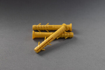 Three yellow dowels on a gray background