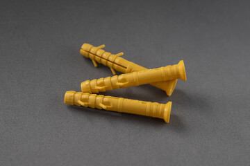 Three yellow dowels on a gray background