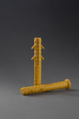 Three yellows dowels on a gray background