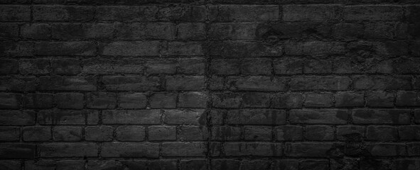 Fototapeta na wymiar An old brick wall painted in black paint texture background
