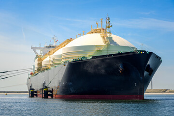 Low angle view of a large gas tanker ship in harbour on a clear summer day. Port of Rotterdam,...