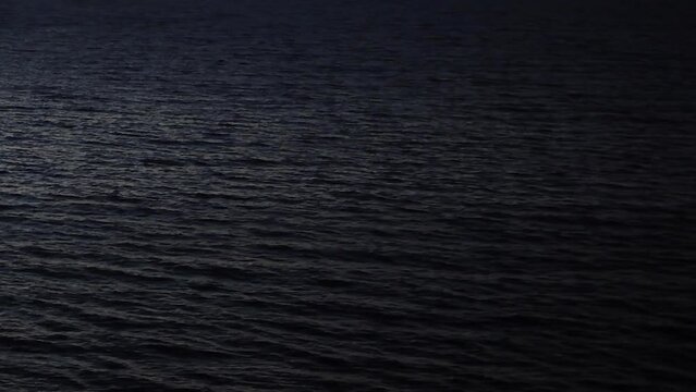 Sea calm waves full frame night background ocean's day 40 seconds long clip