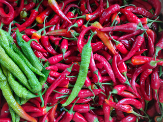 red and green hot pepper pods on the counter in the supermarket