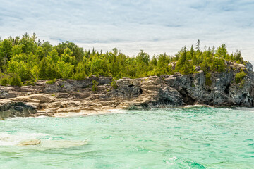 Colourful green waters at Indian Head Cove on lake Huron in Bruce Peninsula National Park and clear blue water in Ontario, Canada. Located between The Grotto and Overhanging rock tourist attractions.