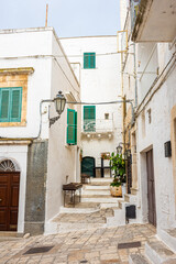 Fototapeta na wymiar Beautiful and cozy white streets in the town historic center of Ostuni, Apulia Italy