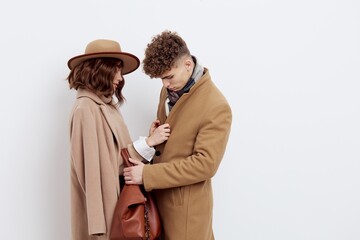 a happy couple is standing in autumn , stylish clothes and no need to hug each other looking at each other