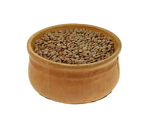 Uncooked lentils in clay bowl isolated on white background with clipping path