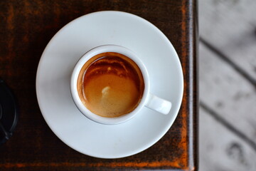Cup of fresh made coffee served in cup on dark background. Coffee background. 