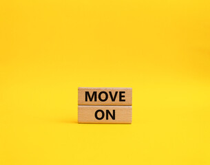 Move on symbol. Wooden blocks with words Move on. Beautiful yellow background. Business and Move on concept. Copy space.