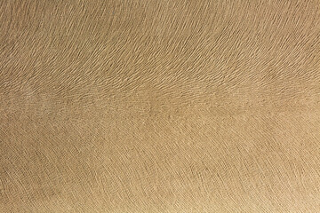 Artificial suede light brown background, textile imitation, velvet texture.
