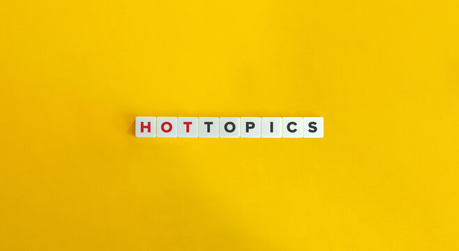 Hot Topics Phrase on Letter Tiles on Yellow Background. Minimal Aesthetics.