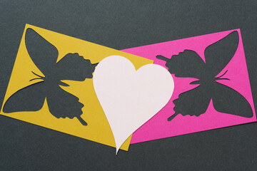pink heart and stencil with butterfly shapes