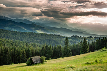 Fototapeta na wymiar Cottage on green valley at sunset, Tatra mountains