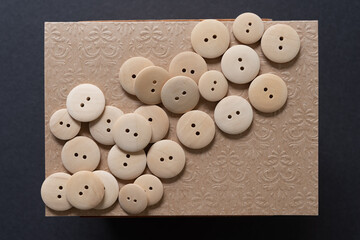 wood buttons on fancy plain brown paper background