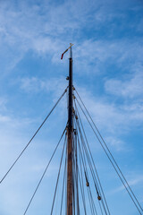 mast of a sailing ship against a blue sky