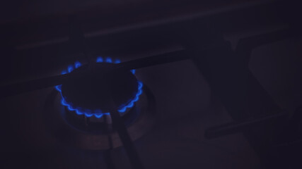 Closeup of blue gas flame on domestic kitchen stove. Gas cooker with burning flames