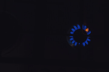 Closeup of blue gas flame on domestic kitchen stove. Gas cooker with burning flames