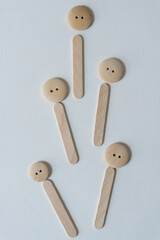 wooden buttons and sticks on blank paper