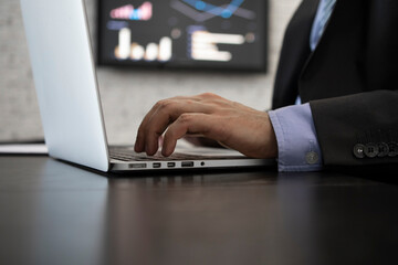 Close-up photo of male hand typing on keyboard in the office