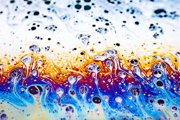 Beautiful psychedelic abstraction formed by light on the surface of a soap bubble